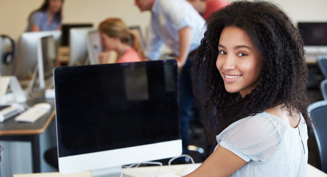 Female Student Using Computer In Classroom