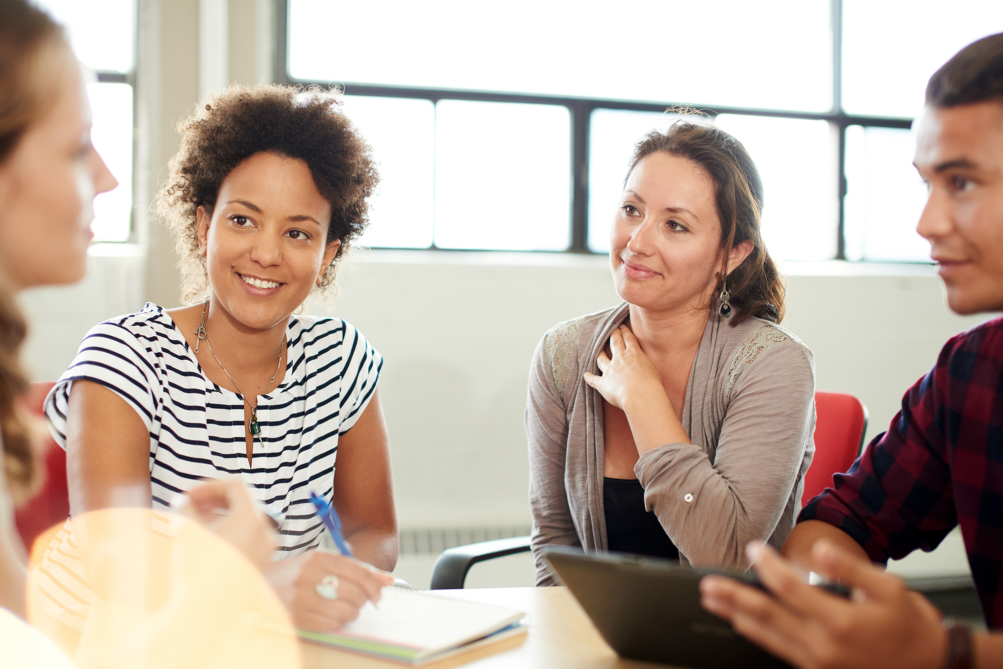 teachers sitting at a table and discussing something